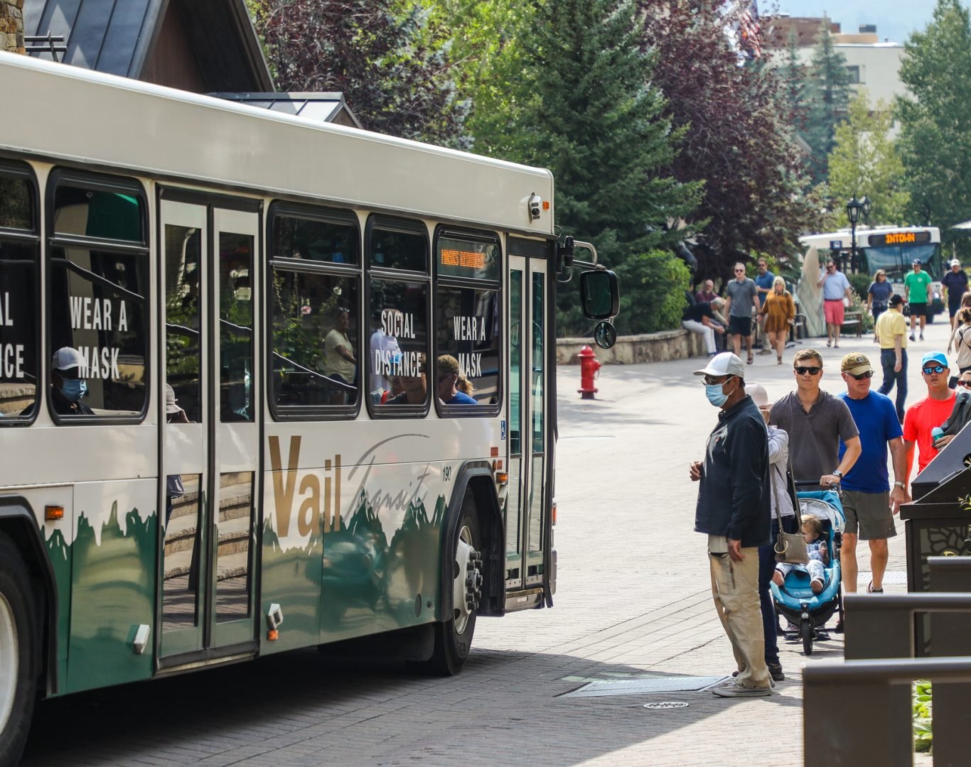 People wait to board and Intown bus Tueday in Vail. Masks are still required on public transportation.